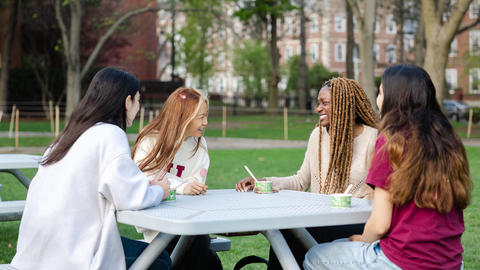 Students talk at a table over ice cream