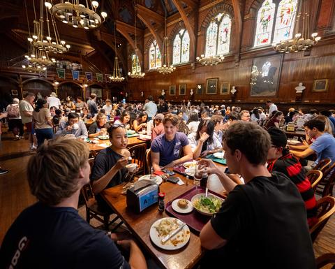 Students eat lunch at a table in Annenberg Dining Hall.